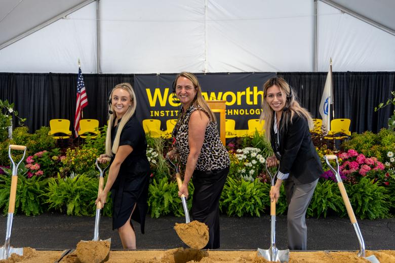 three women holding shovels at a groundbreaking ceremony