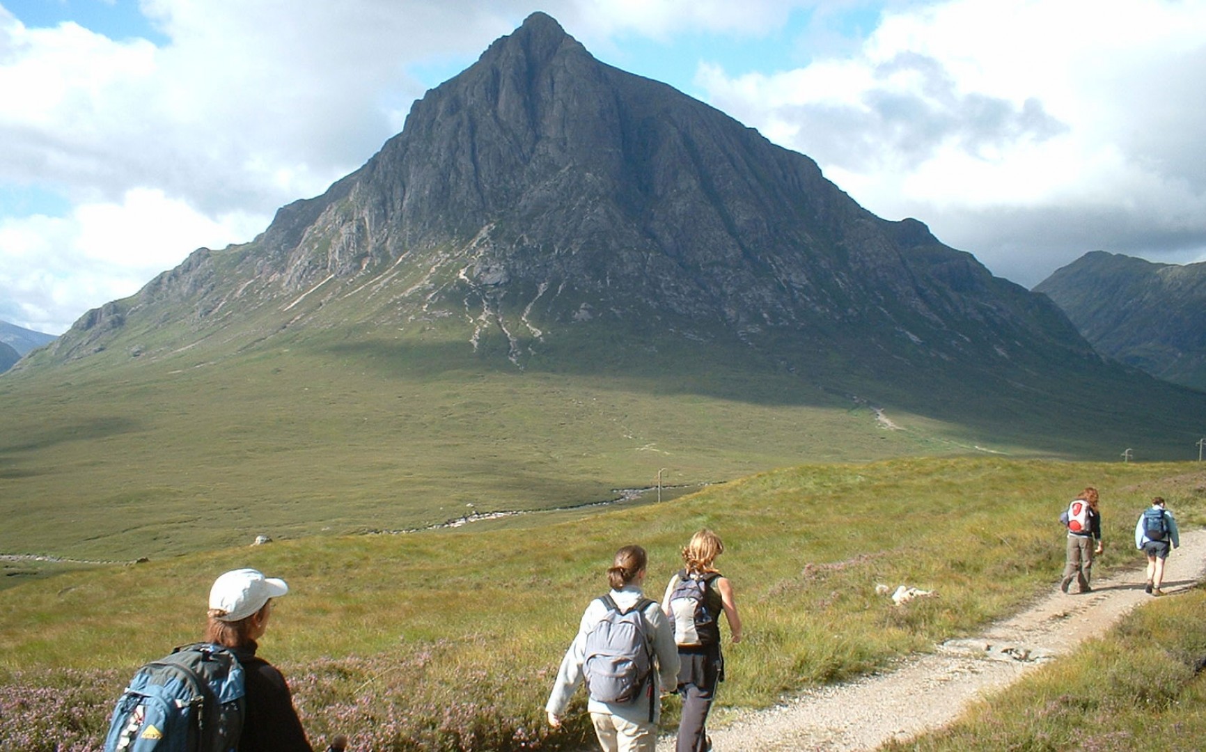 picture of hikers on the West Highland Way with mountain scenery