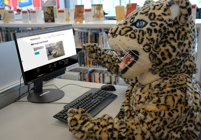The leopard mascot examines a computer