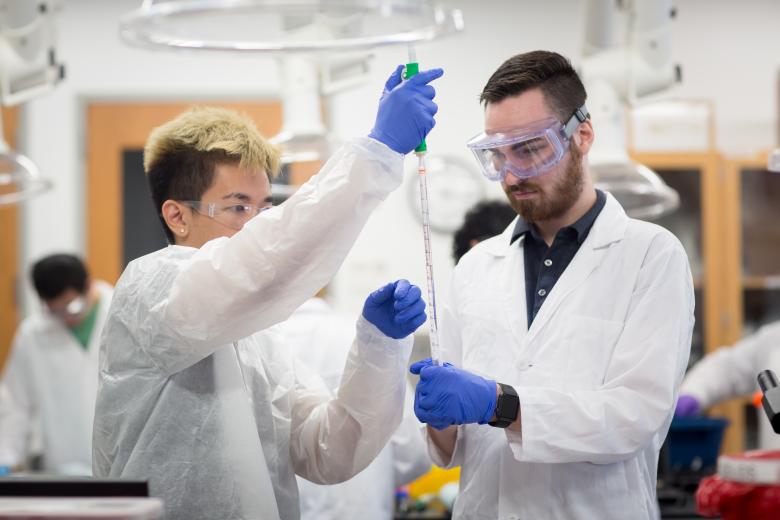 Students working with long pipette 