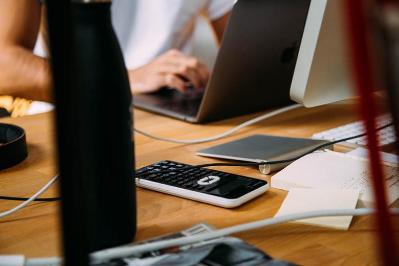 Calculator and woman on computer