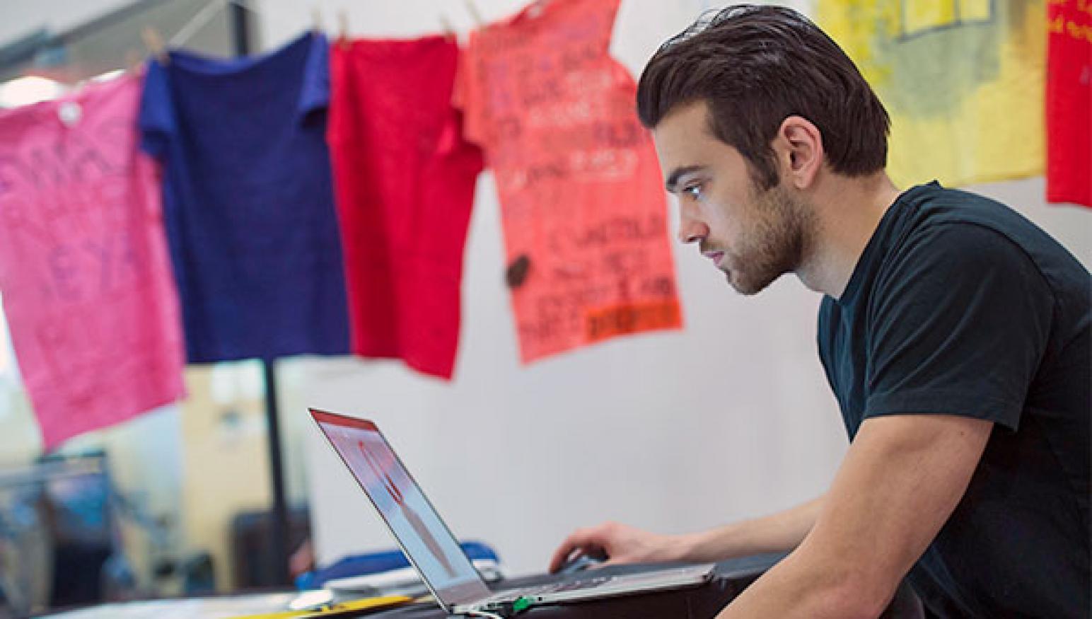 A male student works on his laptop