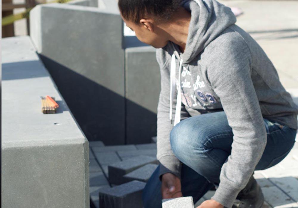 Female Student Laying Brick