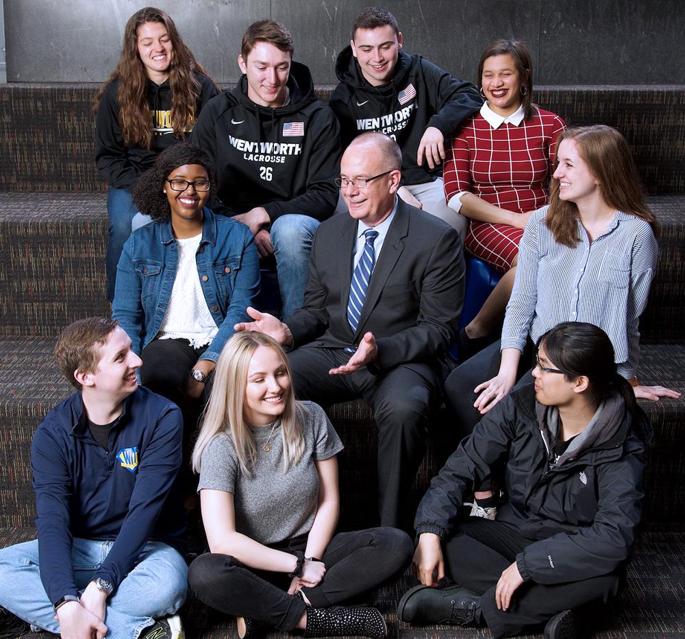 President Thompson sitting surrounded by Wentworth students.