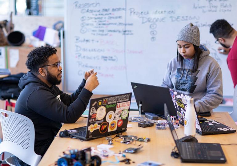 Students working in maker space on campus.