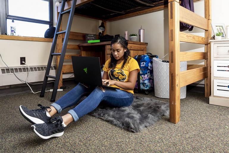 Student on laptop in dorm